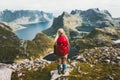 Woman alone with backpack exploring mountains of Norway