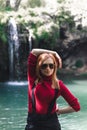 Woman alone sitting, motorcyclists travelers. travel nature Forests, mountains, beautiful waterfall on background. summer day.