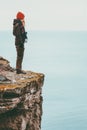 Woman alone standing on cliff edge above sea Travel Lifestyle concept Solitude melancholy emotions Royalty Free Stock Photo