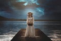 Woman alone on surreal lake pier Royalty Free Stock Photo