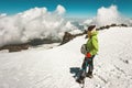 Woman alpinist climbing in mountains