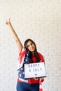 woman with american flag holding lightbox with words Happy 4 July