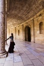 Woman in ancient corridor