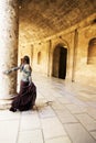 Woman in ancient corridor