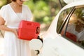 Woman are angry her car ran out of fuel, but her has the gasoline fuel spare for refuel oil. Automotive or transportation concept Royalty Free Stock Photo