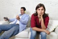 Woman angry and upset while husband or boyfriend plays videogames ignoring her