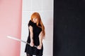 Woman anime with red hair with Japanese samurai sword Royalty Free Stock Photo