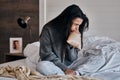 Woman, anxiety and paper bag stress breathing on bed in house or home bedroom in divorce crisis, marriage fail or widow