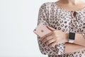 Woman with Apple Watch holding iPhone 6 S Rose Gold