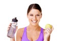 Woman, apple and water bottle in portrait for healthy food choice, wellness and diet on a white background. Young model Royalty Free Stock Photo