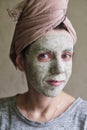 The woman applied green clay to her face as part of her regular cosmetic procedures