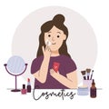 Woman applies a cream to her face. Cosmetics, skincare, makeup concept