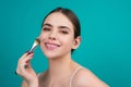 Woman applies powder on the face using makeup brush. Beautiful girl doing contouring apply blush on cheeks. Face beauty Royalty Free Stock Photo