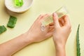 Woman applying aloe gel onto her hands on color background Royalty Free Stock Photo