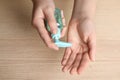 Woman applying antiseptic gel on hand against background, top view Royalty Free Stock Photo