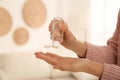 Woman applying antiseptic gel at home Royalty Free Stock Photo