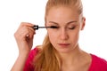 Woman applying black mascara on eyelashes, doing makeup. Royalty Free Stock Photo