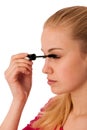 Woman applying black mascara on eyelashes, doing makeup. Royalty Free Stock Photo