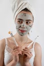 Woman applying with brush black clay mud facial mask isolated on white Royalty Free Stock Photo