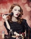 Woman applying cosmetics Royalty Free Stock Photo