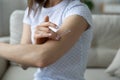 Woman applying cream on arm using natural treatment closeup view Royalty Free Stock Photo