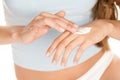 Woman applying cream on hands