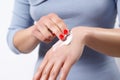 Woman applying cream on hands