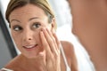 Woman applying daily cream on her face Royalty Free Stock Photo