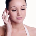 Woman applying creme on face