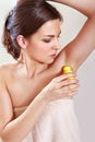 Woman applying deodorant Royalty Free Stock Photo