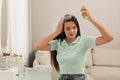 Woman applying dry shampoo onto her hair at home Royalty Free Stock Photo