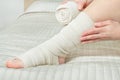 Woman applying elastic compression bandage as a thrombosis prevention after varicose surgery Royalty Free Stock Photo