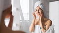 Woman Applying Eye Cream Taking Care Of Skin In Bathroom Royalty Free Stock Photo