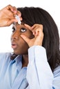 Woman applying eye drops Royalty Free Stock Photo