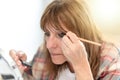 Woman applying eyeshadow powder, light effect Royalty Free Stock Photo