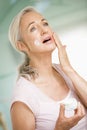 Woman applying face cream Royalty Free Stock Photo