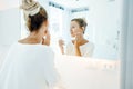 Woman applying face cream in bathroom Royalty Free Stock Photo