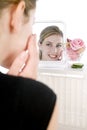 Woman applying facepack in mirror Royalty Free Stock Photo