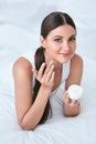 Woman Applying Facial Cream On Face Skin In White Interior Royalty Free Stock Photo