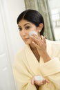 Woman applying facial scrub. Royalty Free Stock Photo