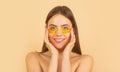 Woman applying golden eye patches. Close up portrait girl. Portrait of beauty woman with eye patches showing an effect Royalty Free Stock Photo