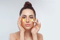 Woman applying golden eye patches. Close up portrait girl. Royalty Free Stock Photo