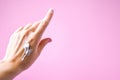 Woman applying hand cream on color background, cream on hand, spa procedures for skin care and beautiful manicure Royalty Free Stock Photo