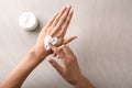 Woman applying hand cream, top view