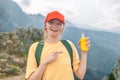 Woman applying insect repellent against mosquito and tick on her hand during hike in nature top mountain. Skin