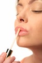 Woman applying lip gloss Royalty Free Stock Photo