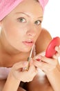 Woman applying lip gloss Royalty Free Stock Photo