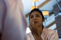 Woman applying lip gloss reflecting on mirror Royalty Free Stock Photo