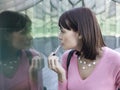 Woman Applying Lip Gloss Royalty Free Stock Photo