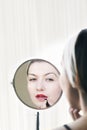 Woman applying lip stick Royalty Free Stock Photo